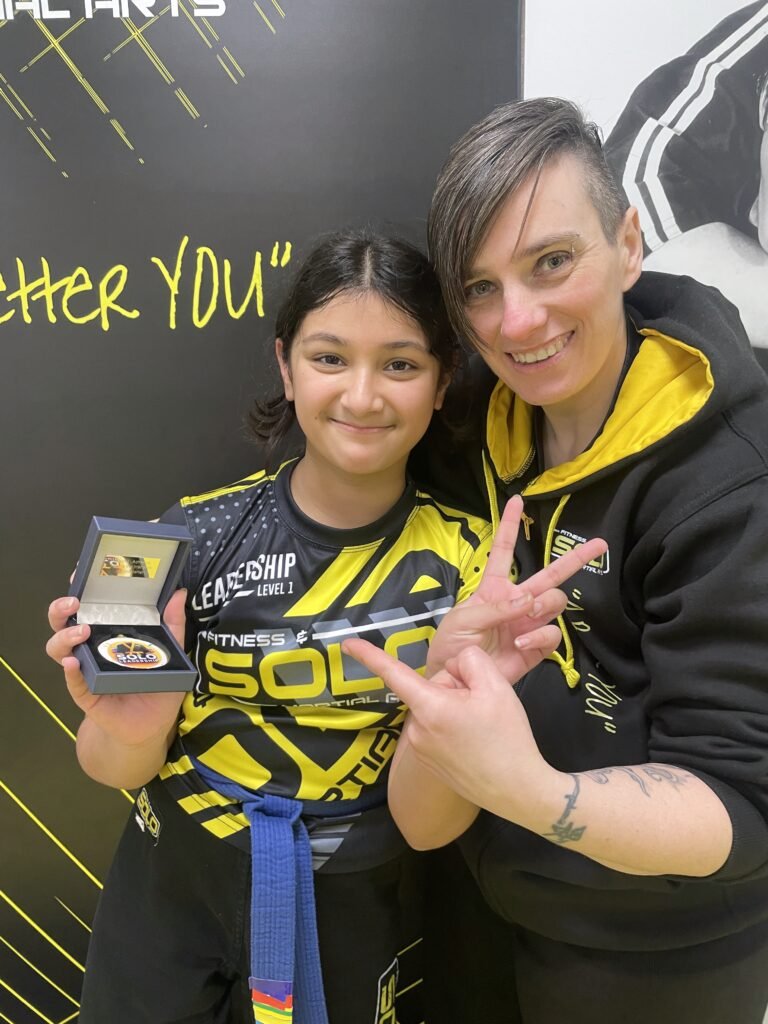 Young student earning Level 1 Leadership Medal at SOLO Martial Arts Academy in Newcastle upon Tyne.